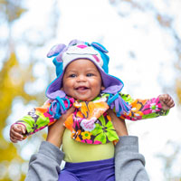 Photo of a black baby being held up in the air Photo of a black baby being held up in the air