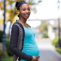 Photo of a pregnant black woman in a park Photo of a pregnant black woman in a park